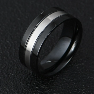 Macro detail of two-tone matte silver and black titanium steel ring on textured background