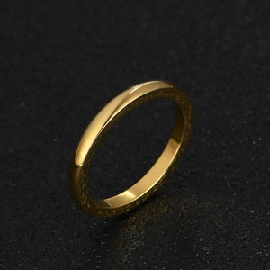 Macro shot of 2mm thin gold-colored stainless steel ring with mirror polished surface
