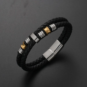 Detailed macro of double-layer braided leather bracelet with mixed metal beads and magnetic clasp