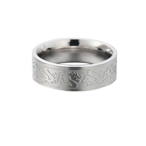 Detailed view of silver stainless steel ring with continuous dragon engraving texture