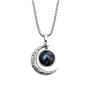 Detailed close-up of crescent moon pendant and glowing constellation charm on box chain