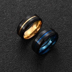 Close-up of matte black brushed stainless steel rings with blue and gold inner plating