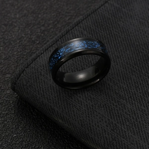 Men's black stainless steel ring with blue Celtic dragon inlay on leather background
