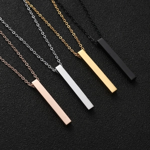 Macro shot of minimalist rectangular bar necklaces in rose gold, silver, gold, and black finishes