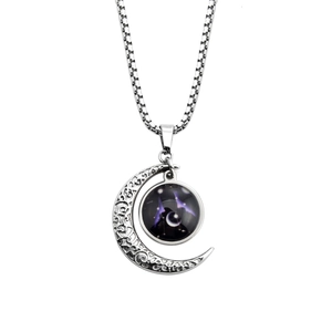 Close-up of silver crescent moon necklace featuring a luminous zodiac star constellation