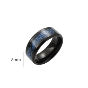 Macro detail of 8mm wide black ring featuring a blue Celtic dragon inlay pattern