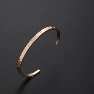 Minimalist C-shaped rose gold stainless steel cuff bracelet with Roman numeral engravings