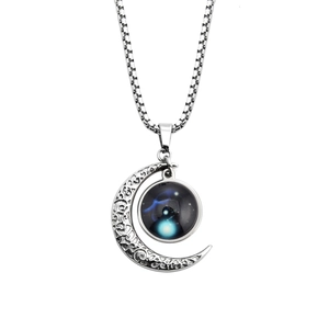 Detailed view of luminous zodiac crescent moon pendant on vintage box chain necklace