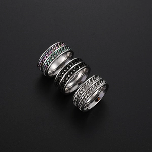 Three stainless steel punk chain rings in silver, black and rainbow colors on black background