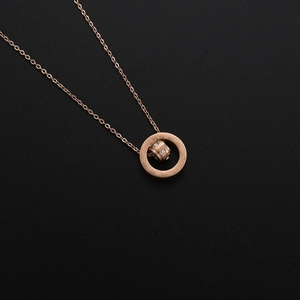 Rose gold double ring necklace with Roman numerals and sparkling crystals on black background
