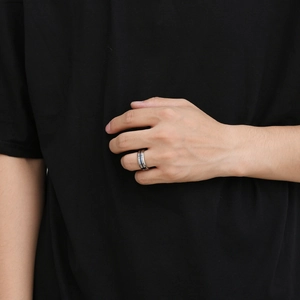 Close-up of 8mm silver tungsten ring with blue grooved inlay on male finger