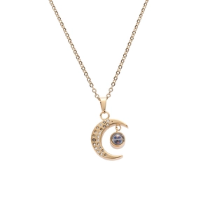 Detail of gold crescent moon necklace with sparkling crystals and projection stone