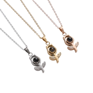 Three tulip projection necklaces in silver, gold, and rose gold finishes on white background
