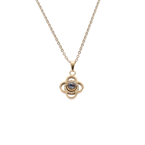 Elegant gold four-leaf clover necklace with sparkling crystals and central projection stone