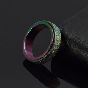 Macro shot of rotatable rainbow matte spinner ring with sparkling frosted texture on metal