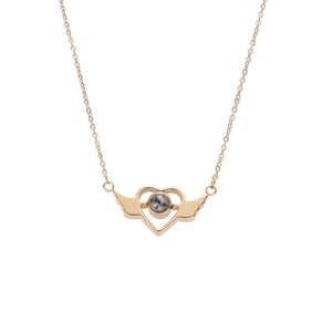 Gold angel wings heart necklace with projection stone on white background
