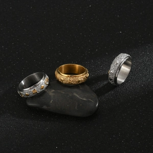 Set of three rotating stainless steel rings with engraved Buddhist mantra patterns
