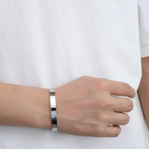 Polished stainless steel C-shaped open cuff bracelet shown on a model wrist