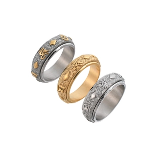 Three spinner rings in gold and silver steel with engraved Buddhist mantra patterns
