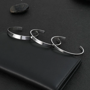 Minimalist C-shaped stainless steel cuff bracelets in polished, brushed, and matte finishes