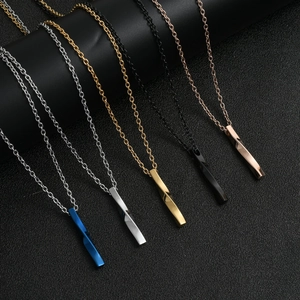 Macro detail of twisted bar pendants in blue silver gold black and rose gold steel