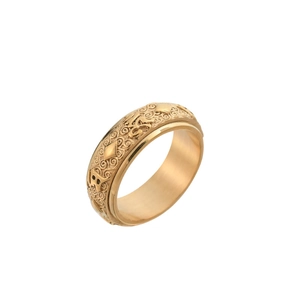 Macro detail of golden spinning ring with engraved Buddhist mantra and floral pattern
