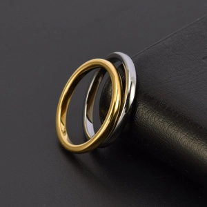 Minimalist 2mm tungsten rings in gold and silver finish on black leather stand