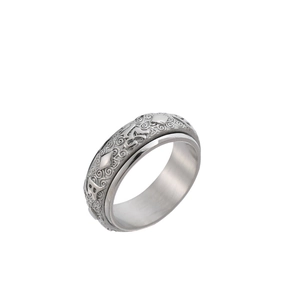 Macro shot of rotatable stainless steel ring with engraved Buddhist mantra symbols