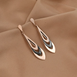 Rose gold long teardrop earrings with frosted texture and Love engraving on a fabric background
