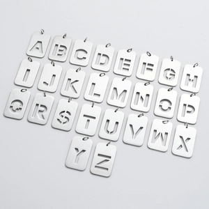 Detailed view of 26 alphabet letters and dollar sign cutout steel pendants with brushed finish