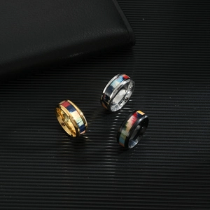 Polished stainless steel rings with colorful wood grain inlay in gold, silver, and black