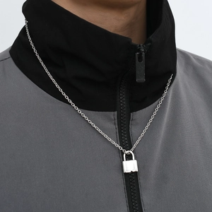 Industrial style stainless steel padlock pendant necklace on a streetwear jacket