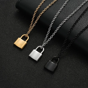 Detailed close-up of three polished lock pendants in gold, silver, and black finish