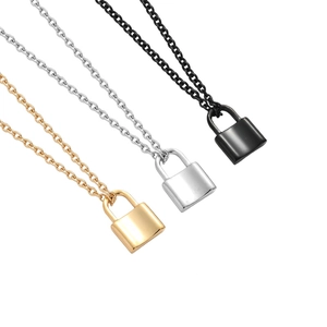 Detailed close-up of lock pendant necklaces in gold, silver, and black polished steel