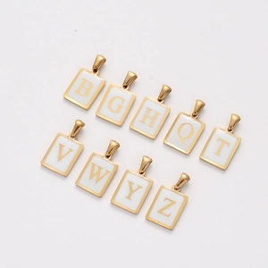 Detail view of nine gold rectangular alphabet charms with white enamel inlay