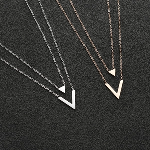 Close-up of double-layer stainless steel V-shaped and triangle pendant necklaces