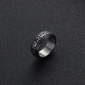 Retro stainless steel rotating ring with Tibetan mantra engraving on black background