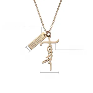Detail of gold titanium steel cross necklace with engraved rectangular pendant and charm