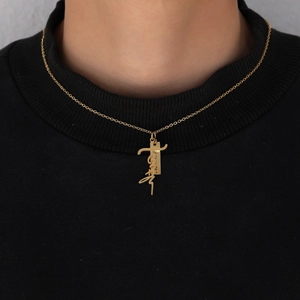 Detailed close-up of gold stainless steel Faith letter pendant with a cross on a chain