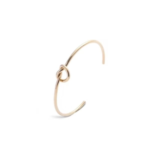 Detailed close-up of a minimalist rose gold knotted open cuff bracelet for women