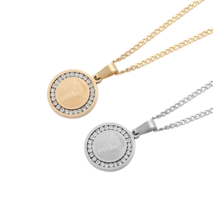 Macro detail of gold and silver medical caduceus necklaces with cubic zirconia inlay