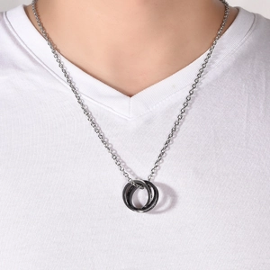 Modern double ring necklace in black and silver stainless steel on a male model