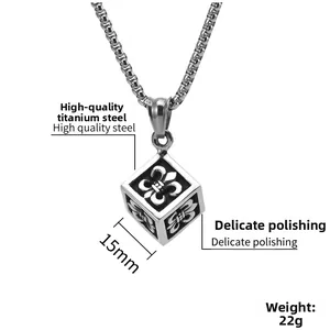 Macro shot of 15mm titanium steel cube pendant with engraved fleur-de-lis motifs