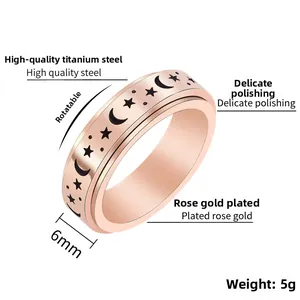 Macro view of rose gold spinner ring featuring engraved star and moon patterns