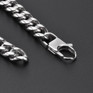 Macro view of silver Cuban link chain with high-polish finish and heavy lobster clasp