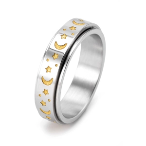 Detailed close-up of a silver spinner ring with golden stars and moon relief pattern