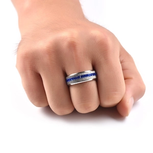 Macro detail of brushed silver stainless steel ring with square-cut blue stones