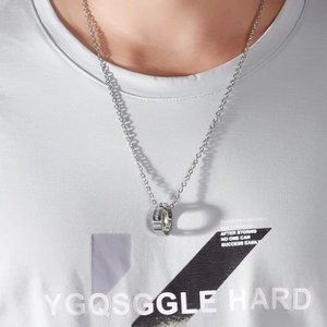 Detail of interlocking silver double ring necklace with engraved text on model
