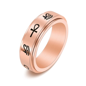 Macro shot of rose gold stainless steel spinning ring with Ankh and Eye of Horus symbols