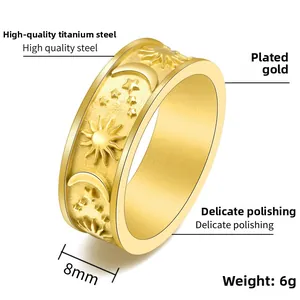 Detail view of 8mm wide celestial sun moon and star embossed gold titanium steel ring